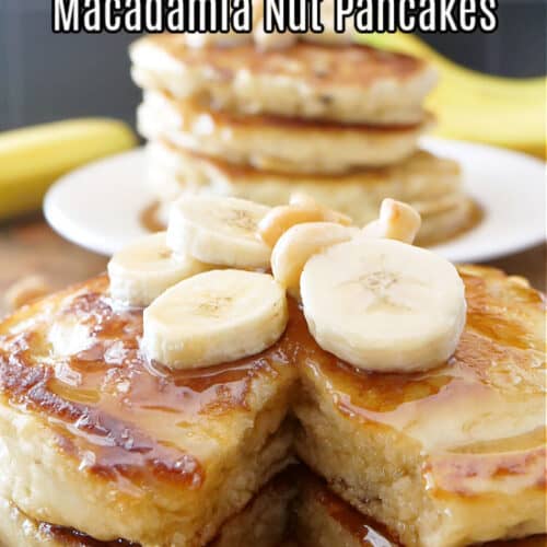 Two plates with stack of pancakes on white plates, topped with maple syrup.