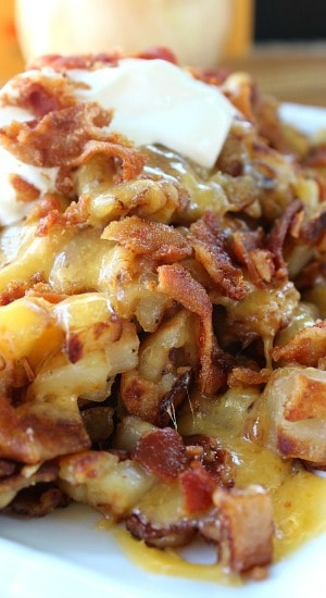 A white plate with breakfast potatoes on it.