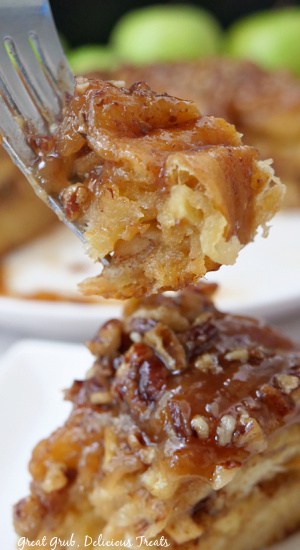 A bite of crescent tolls cinnamon roll on a fork.