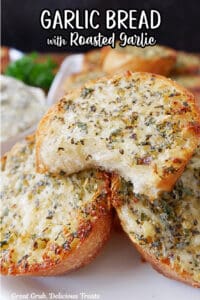A white plate with three small round pieces of garlic bread on it.