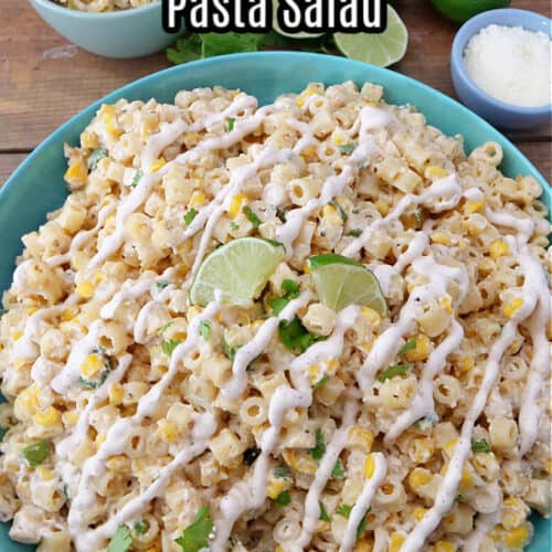 A large blue bowl filled with pasta salad and drizzled with street corn dressing.
