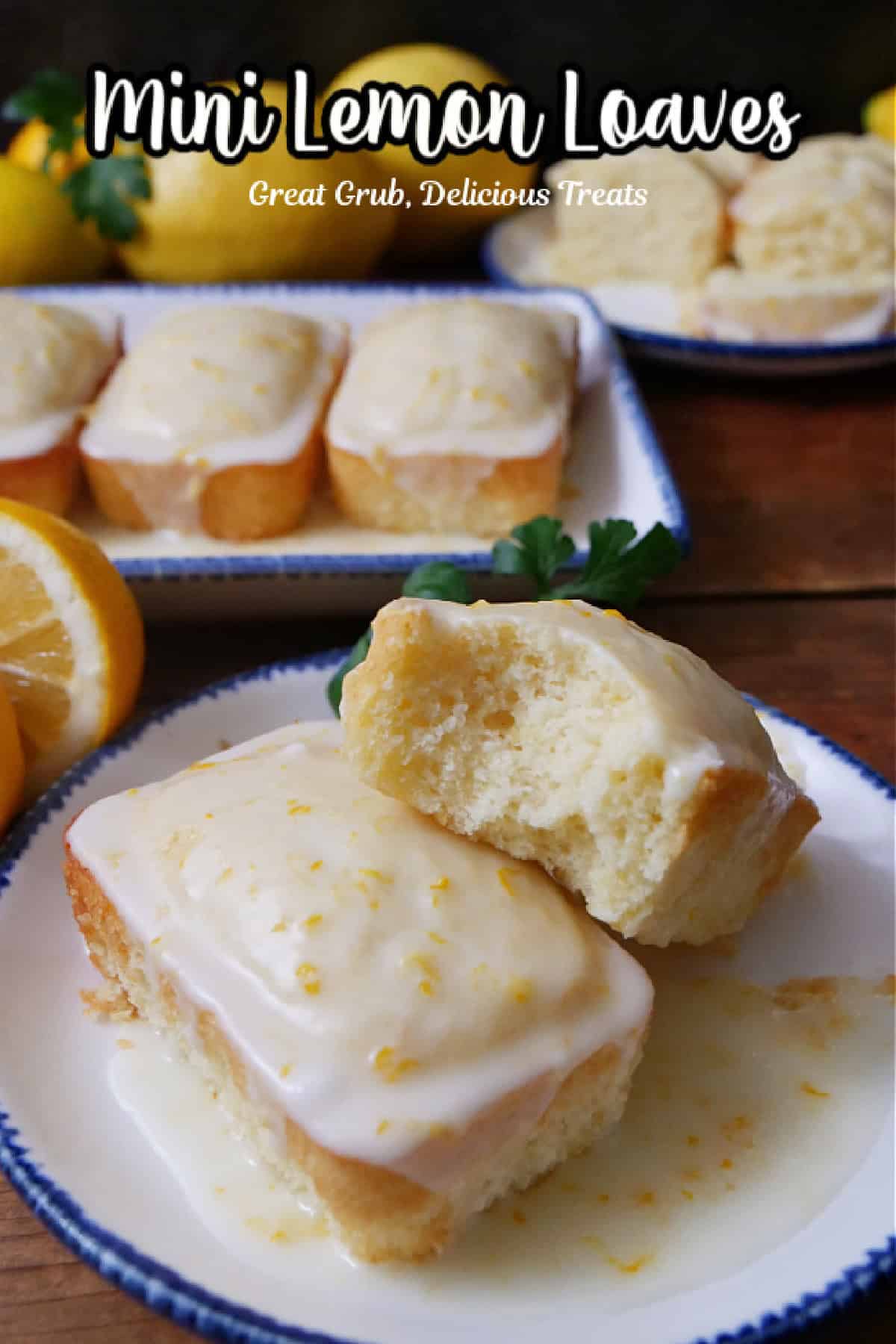 Two lemon mini loaves on a white plate with blue trim.