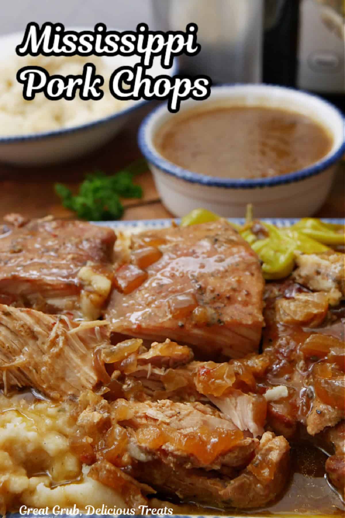 A white plate with blue trim with four boneless, slow cooked pork chops on it.
