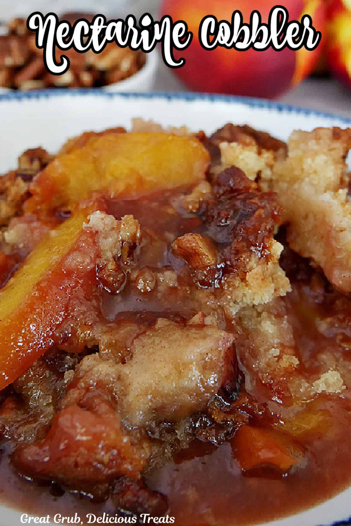 A white bowl with blue trim filled with nectarine cobbler.