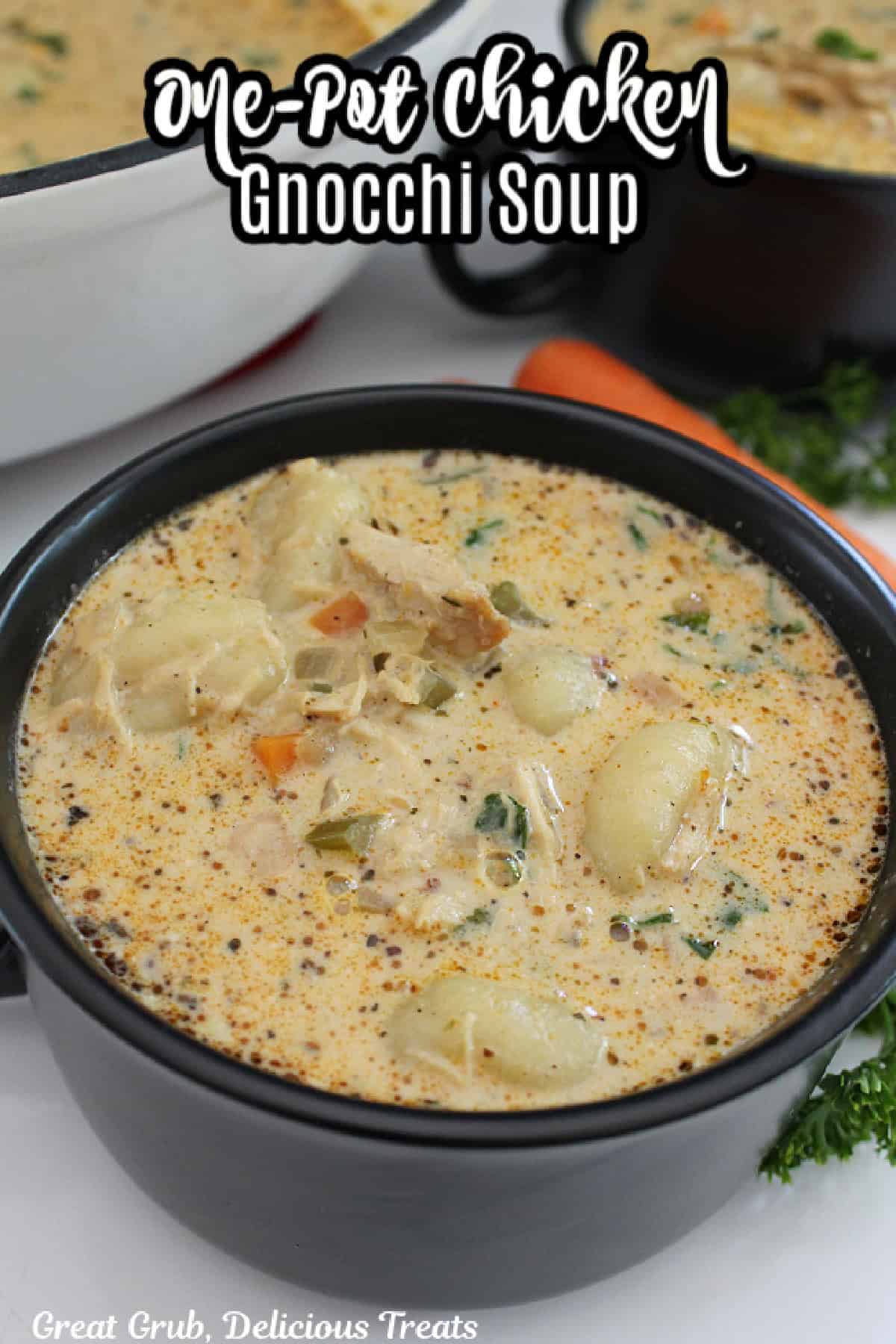 A black soup bowl filled with homemade chicken gnocchi soup.