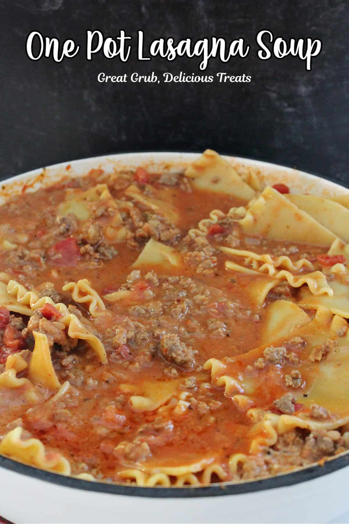 A white cast iron pot with homemade lasagna soup in it.