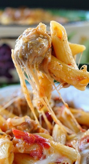 Italian Sausage Penne Casserole A fork filled with a bite of pasta with sausage.