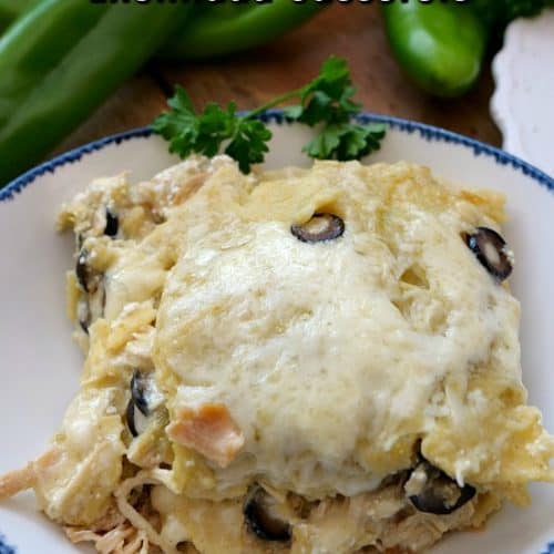 A slice of enchilada casserole on a white plate.