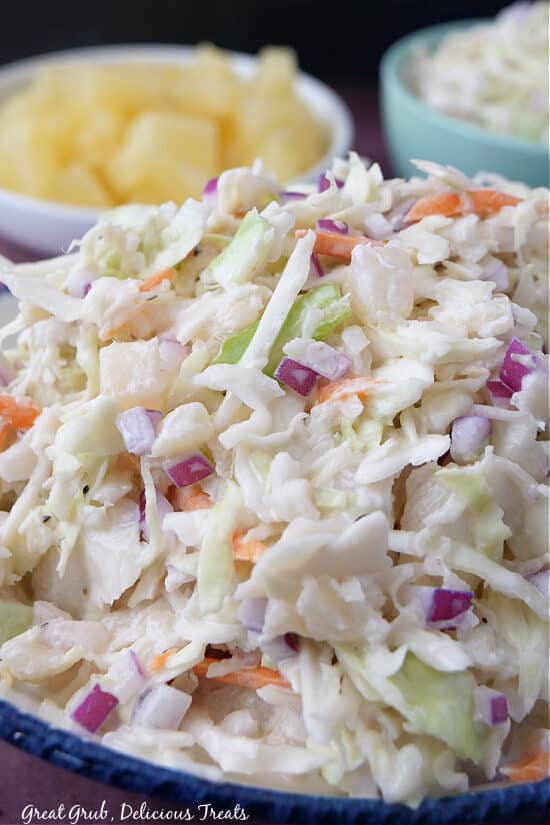 A close up of a bowl filled with pineapple colesalw.