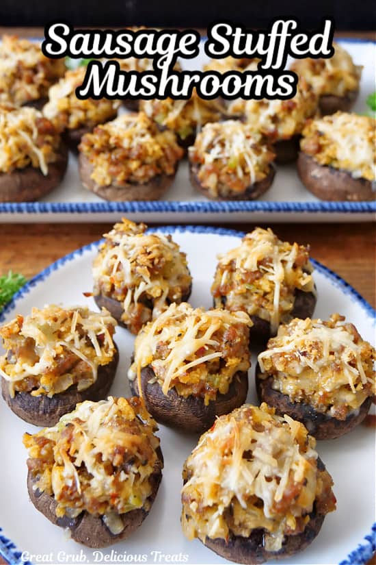 Two white plates with blue trim filled with sausage stuffed mushrooms.